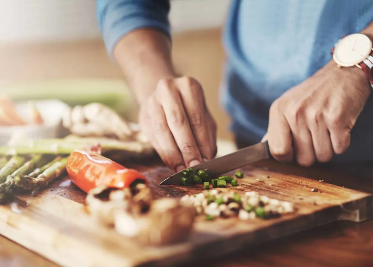 Cropped shot of a man preparing a healthy meal at home
